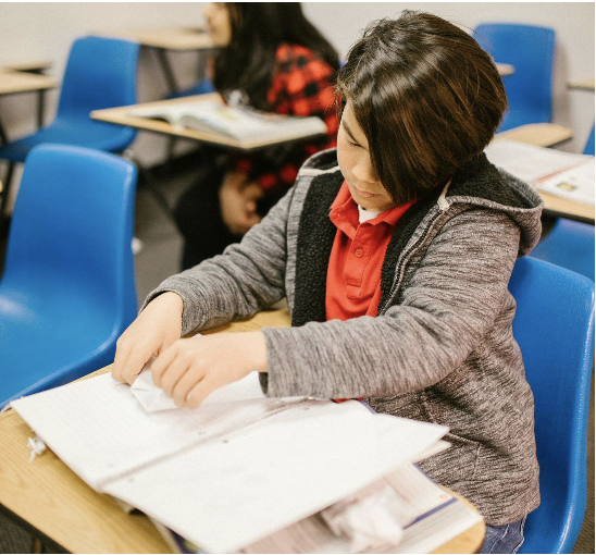 a child sitting at a desk working