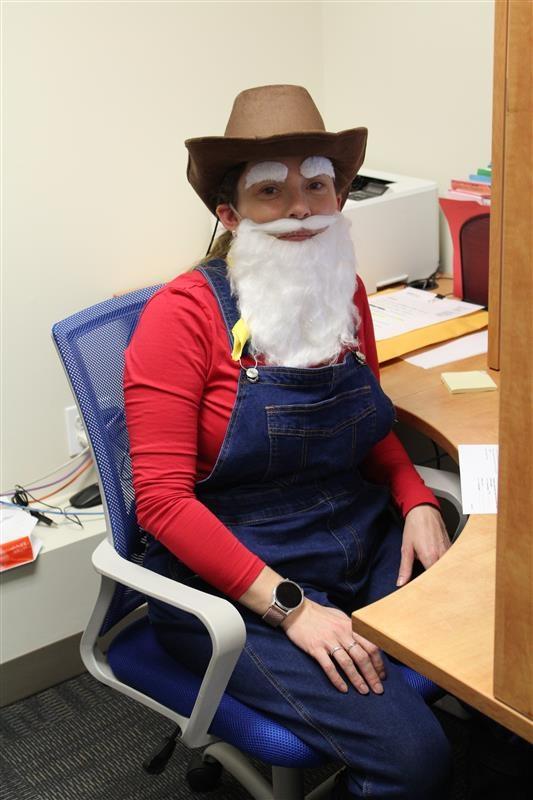 A Woman dressed as stinky pete from toy story